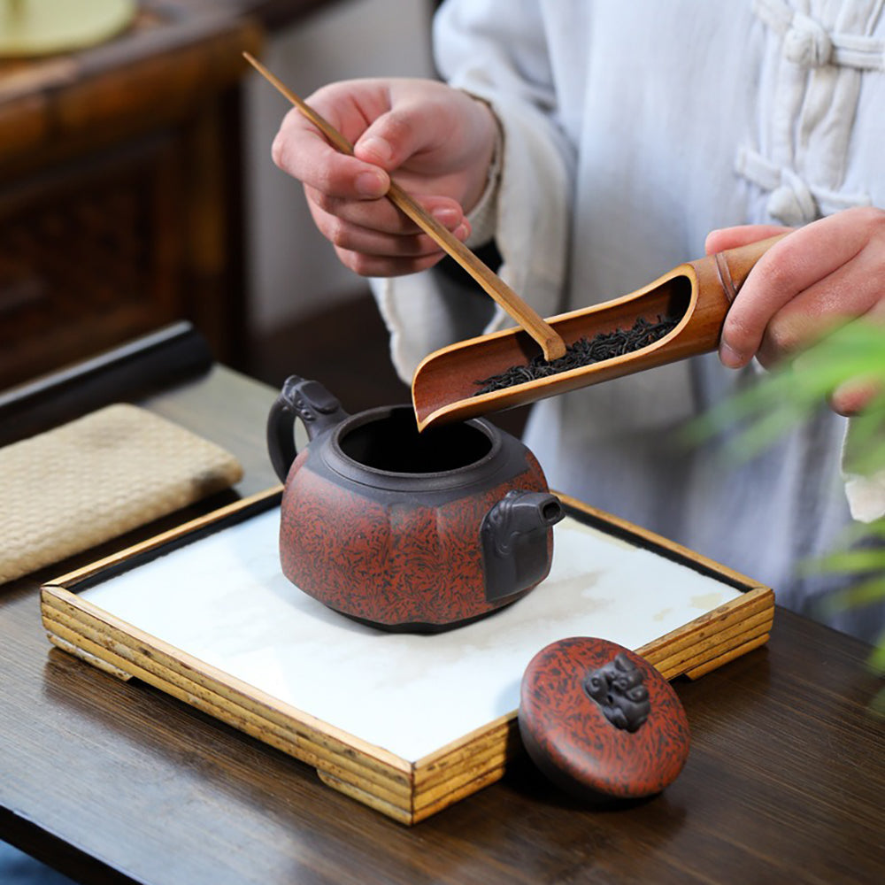 Elegant purple clay teapot in a gift box, showcasing craftsmanship
