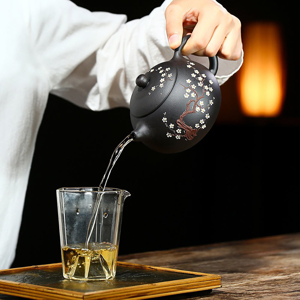 Aerial view of the Yixing black clay teapot filled with brewed tea, highlighting its usability and aesthetic appeal.