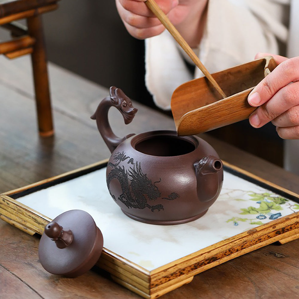 Detailed view of the Yixing double dragons playing with beads teapot highlighting dragon motifs