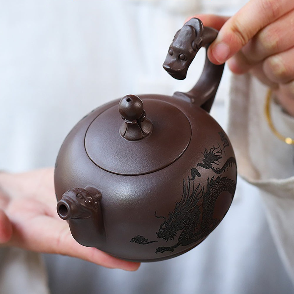 Side angle of the ceramic teapot showcasing the handle and spout designed as dragons