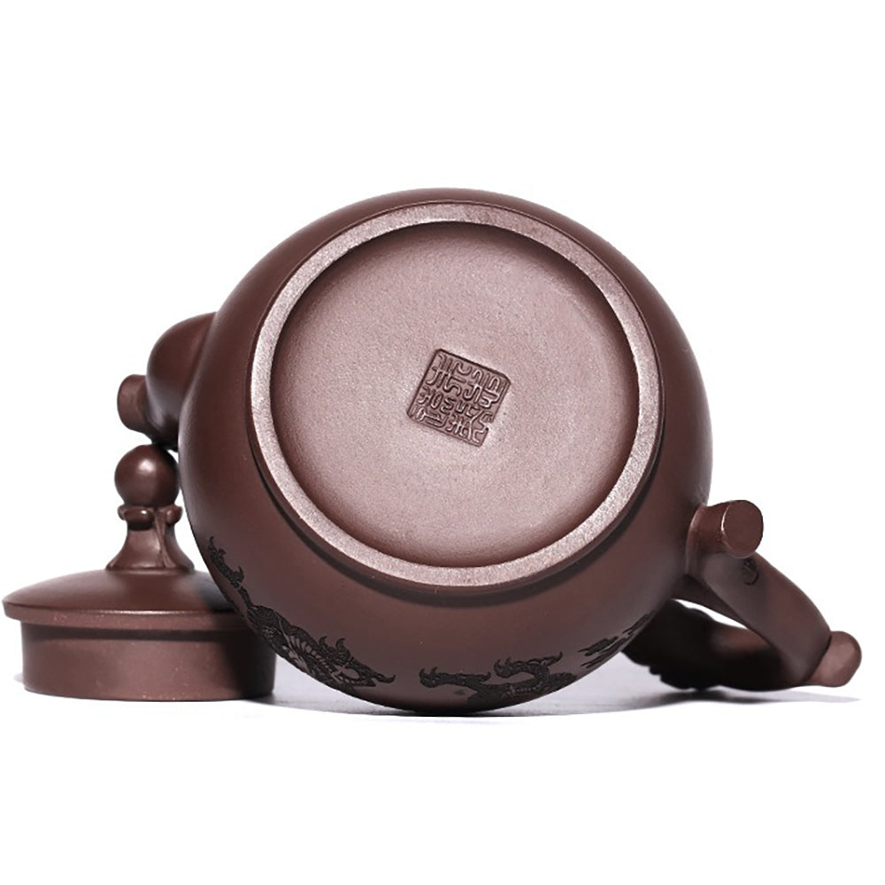 The teapots lid with a bright dragon ball accent, symbolizing auspiciousness