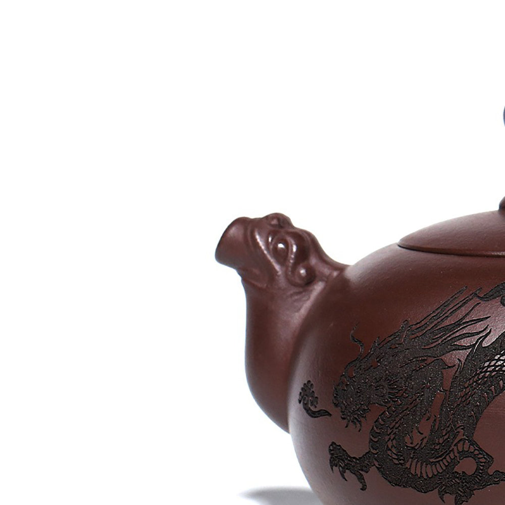 Detailed view of the Yixing double dragons playing with beads teapot highlighting dragon motifs