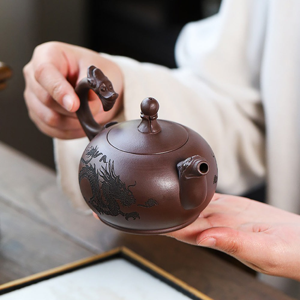 The teapots lid with a bright dragon ball accent, symbolizing auspiciousness