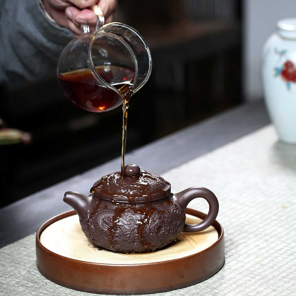 Side view of the majestic Yixing dragon teapot, highlighting the elegant 9-hole water outlet.