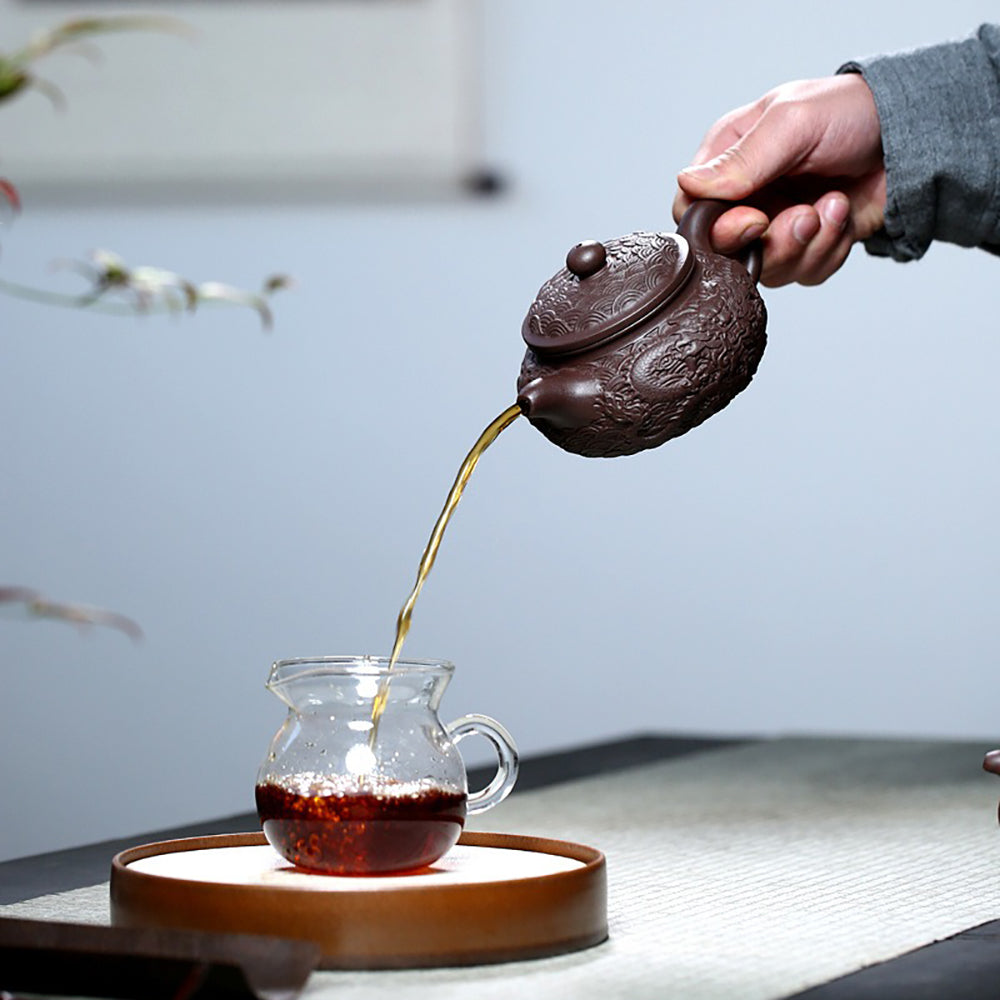 Side view of the majestic Yixing dragon teapot, highlighting the elegant 9-hole water outlet.