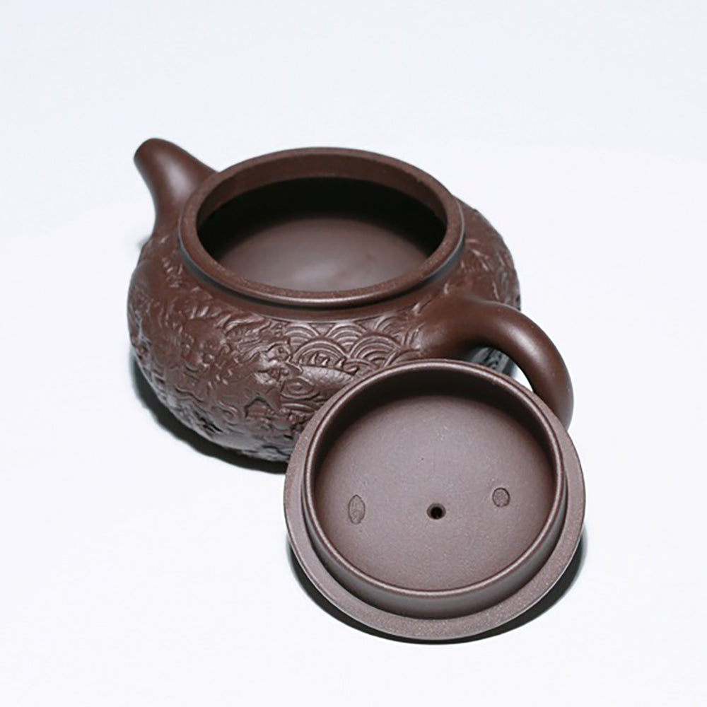Side view of the majestic Yixing dragon teapot, highlighting the elegant 9-hole water outlet.