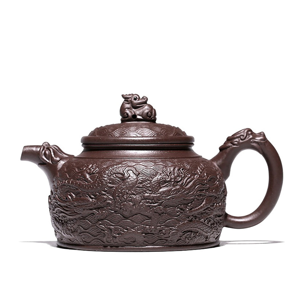 Close-up of embossed dragon and auspicious cloud patterns on purple clay teapot