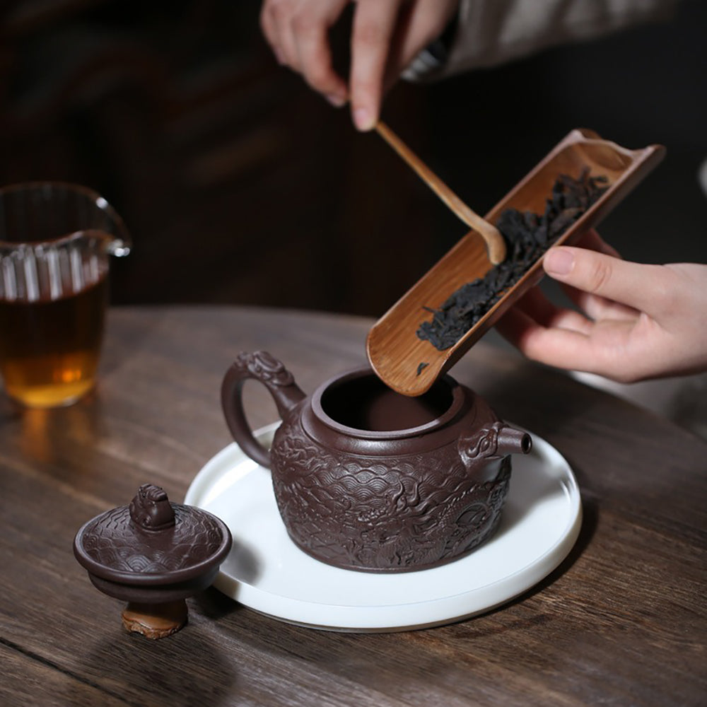 Elegant purple clay teapot with dragon lid button and intricate design