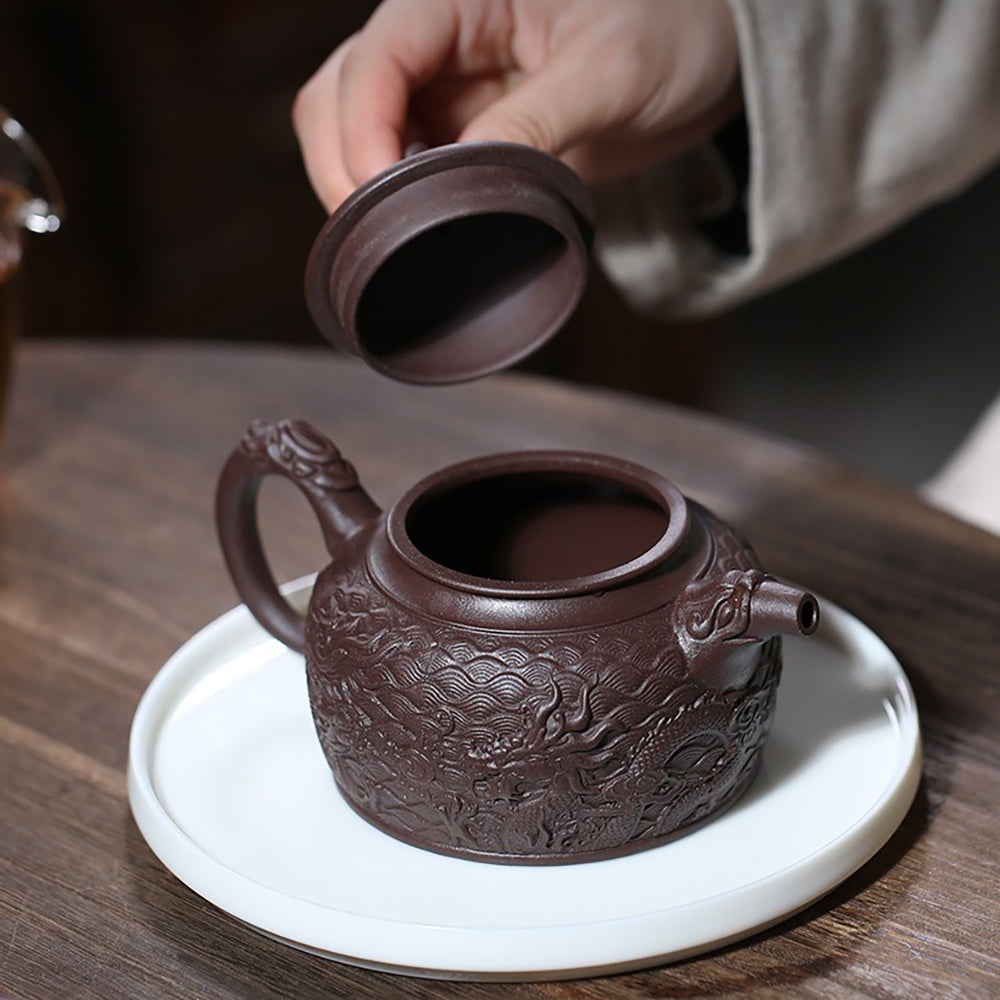 Elegant purple clay teapot with dragon lid button and intricate design