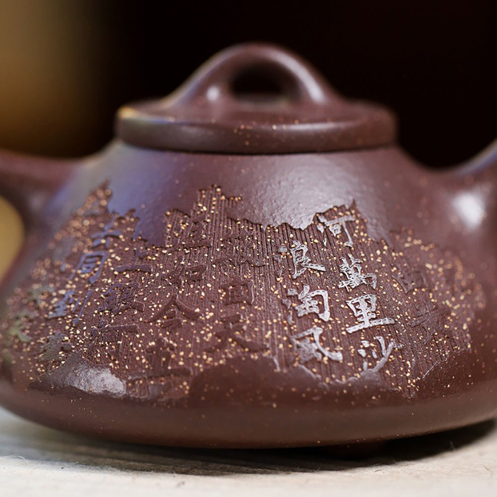 Close-up view of the artisan Yixing purple clay teapot highlighting its elegant curves and intricate details.