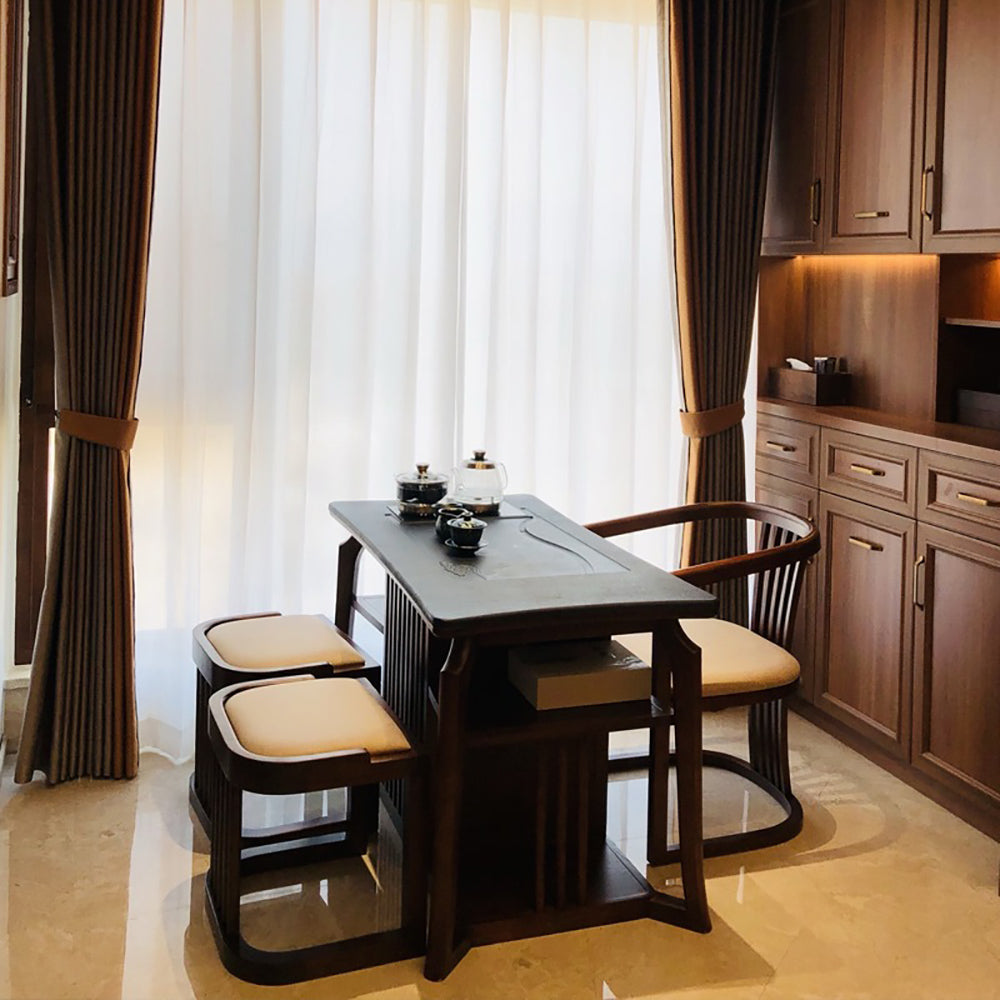 Living room setup featuring an elegant Chinese tea table with chairs, perfect for tea ceremonies