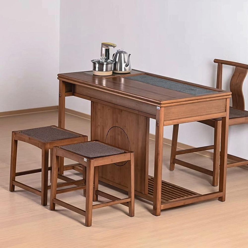 Front view of the elegant bamboo tea table set with chairs in a cozy tea room.
