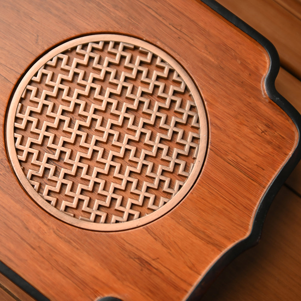 Decorative bamboo and metal tea tray with vibrant tea setup