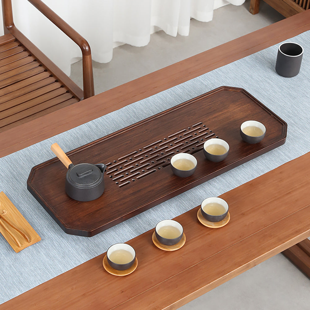 Close-up of ocean-inspired engraved patterns on bamboo gongfu tea tray