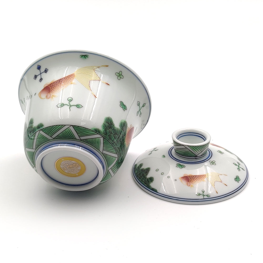 Side view of luxury enamel ceramic tea cup set with goldfish design, detailed craftsmanship