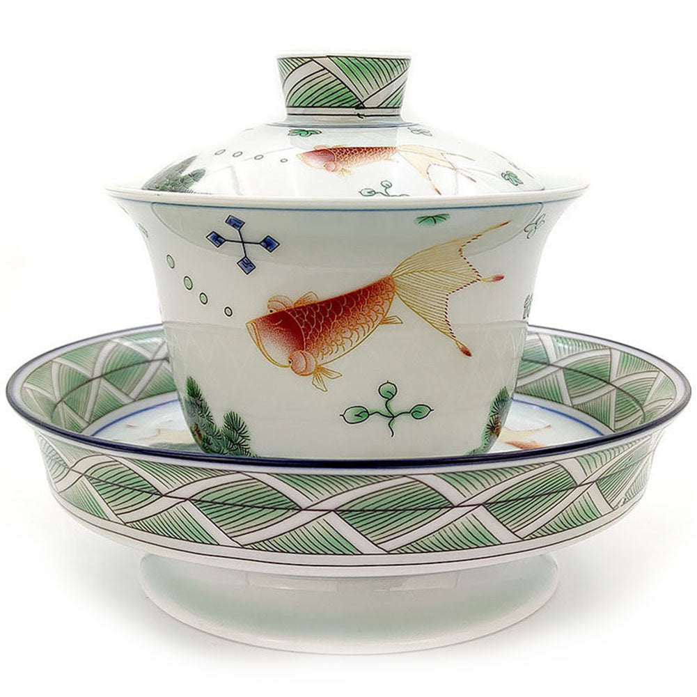 Side view of luxury enamel ceramic tea cup set with goldfish design, detailed craftsmanship