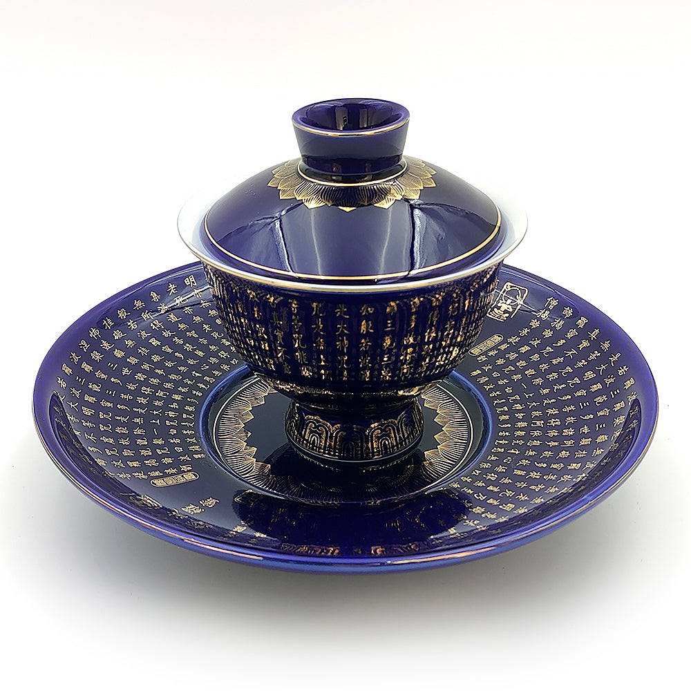 Elegant Heart Sutra Gaiwan tea set, featuring a deep blue glaze and gold rim.