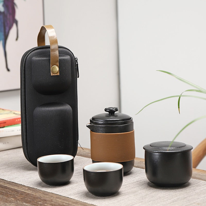 Elegant Black Ceramic Travel Tea Set displayed with teapot and cups, perfect for outdoor adventures.
