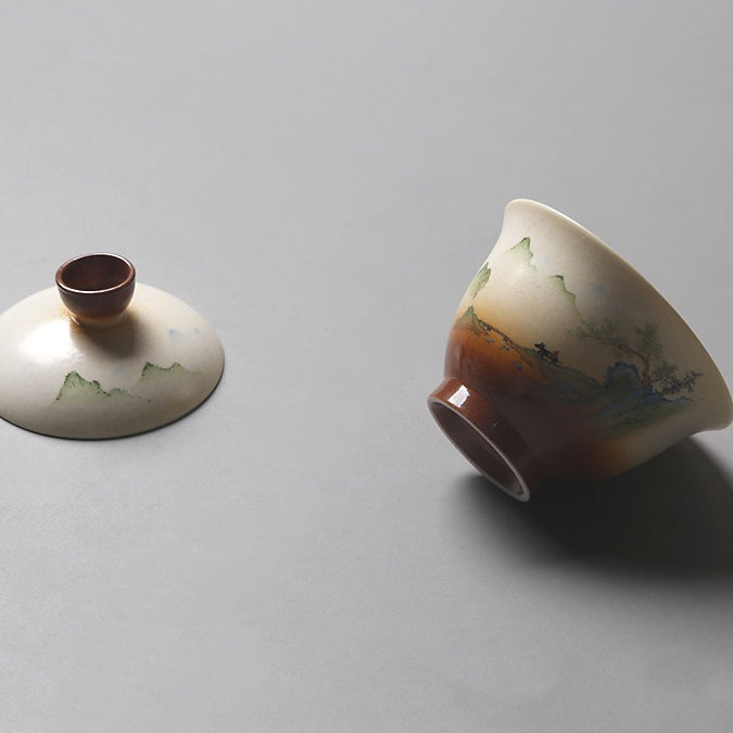 Close-up of the artisan Chinese Gaiwan with vintage landscape painting, highlighting its detailed design.