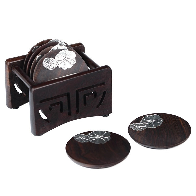 Close-up of premium wooden coasters for coffee cups showing texture and silver detailing