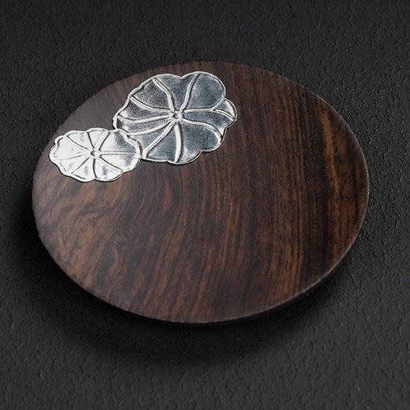 Close-up of premium wooden coasters for coffee cups showing texture and silver detailing