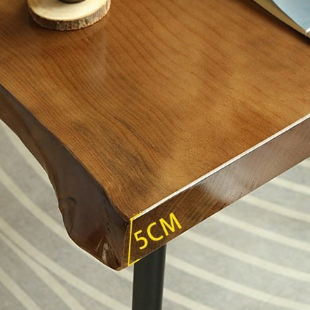 Full view of the Mediterranean raw wood tea table set in a cozy living room with chairs and a cast iron tea tray.