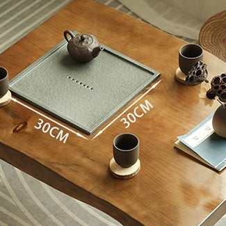 Tea table set placed in a small space, showing the versatility of minimalist design with natural wood furniture.