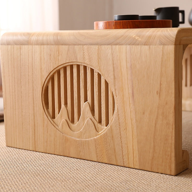 Low coffee table placed in a cozy living room setting, ideal for tea and snacks.