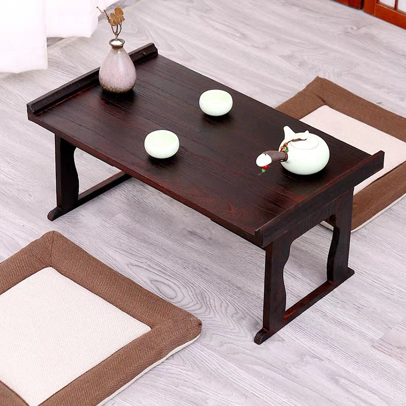 Top-down view of the ZenCraft foldable tea table showcasing its raised edges and black wood texture