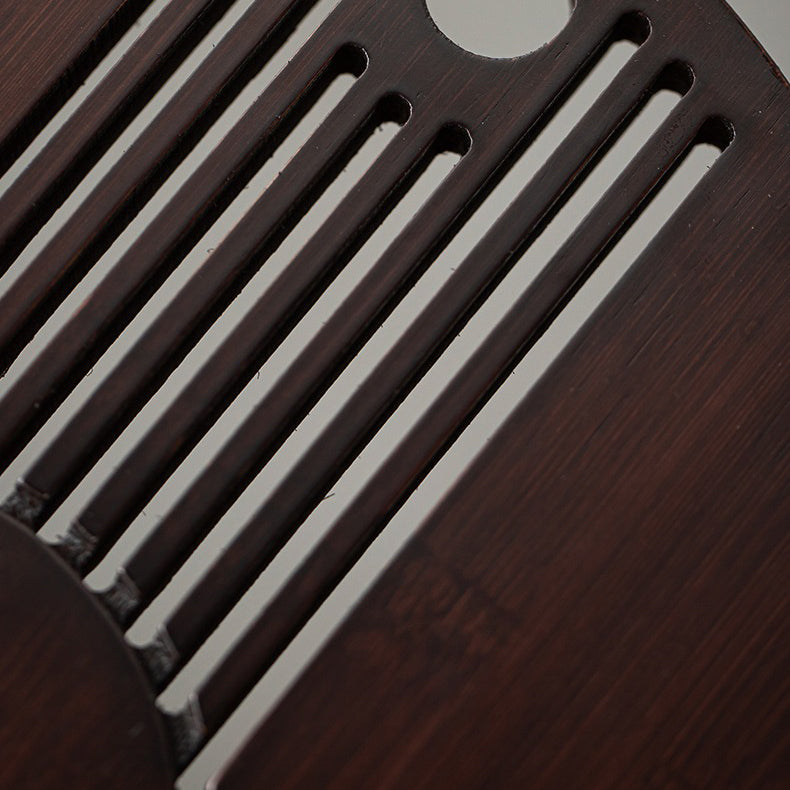 Close-up of bamboo tea tray with hollow striped design for Gong Fu tea
