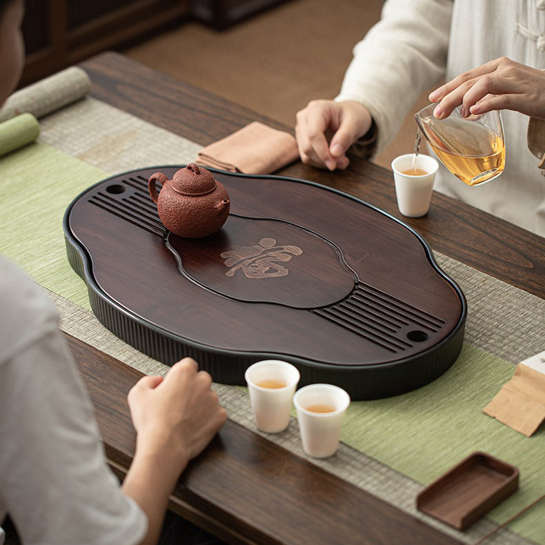 Tea tray placed on a wooden table with Gong Fu tea set for traditional tea ceremony