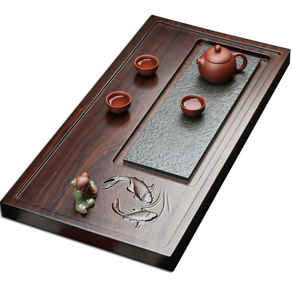Close-up of goldfish carving on minimalist stone and wood tea tray