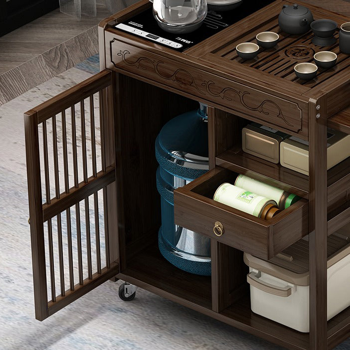 Close-up of the tea tray and water container on the nanmu wood tea cart.