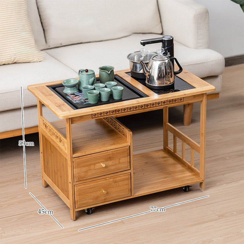 Compact tea serving cart showcasing its storage drawers and kettle.