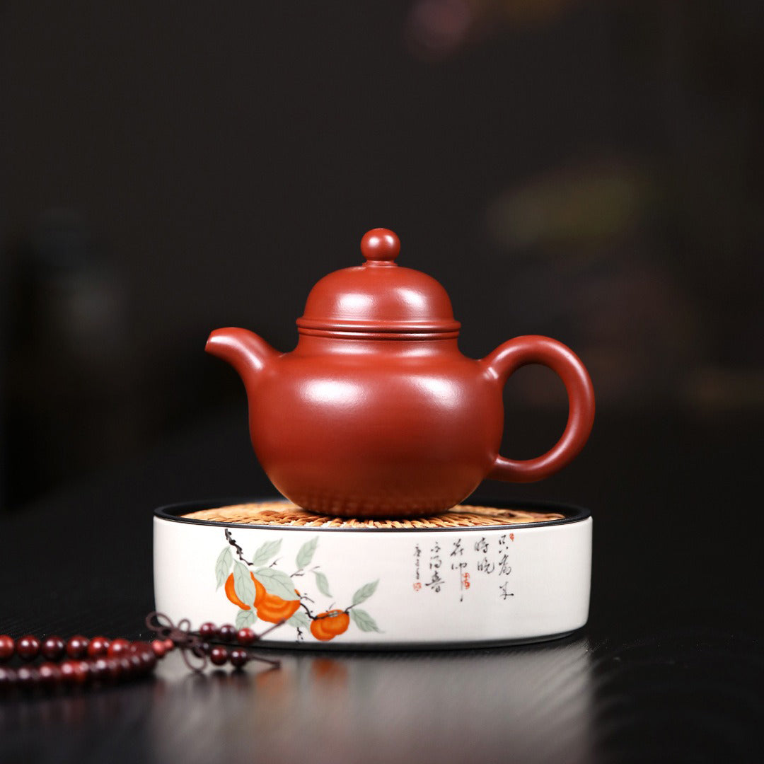 Yixing red clay teapot filled with freshly brewed Gongfu tea, highlighting its functionality and elegance.
