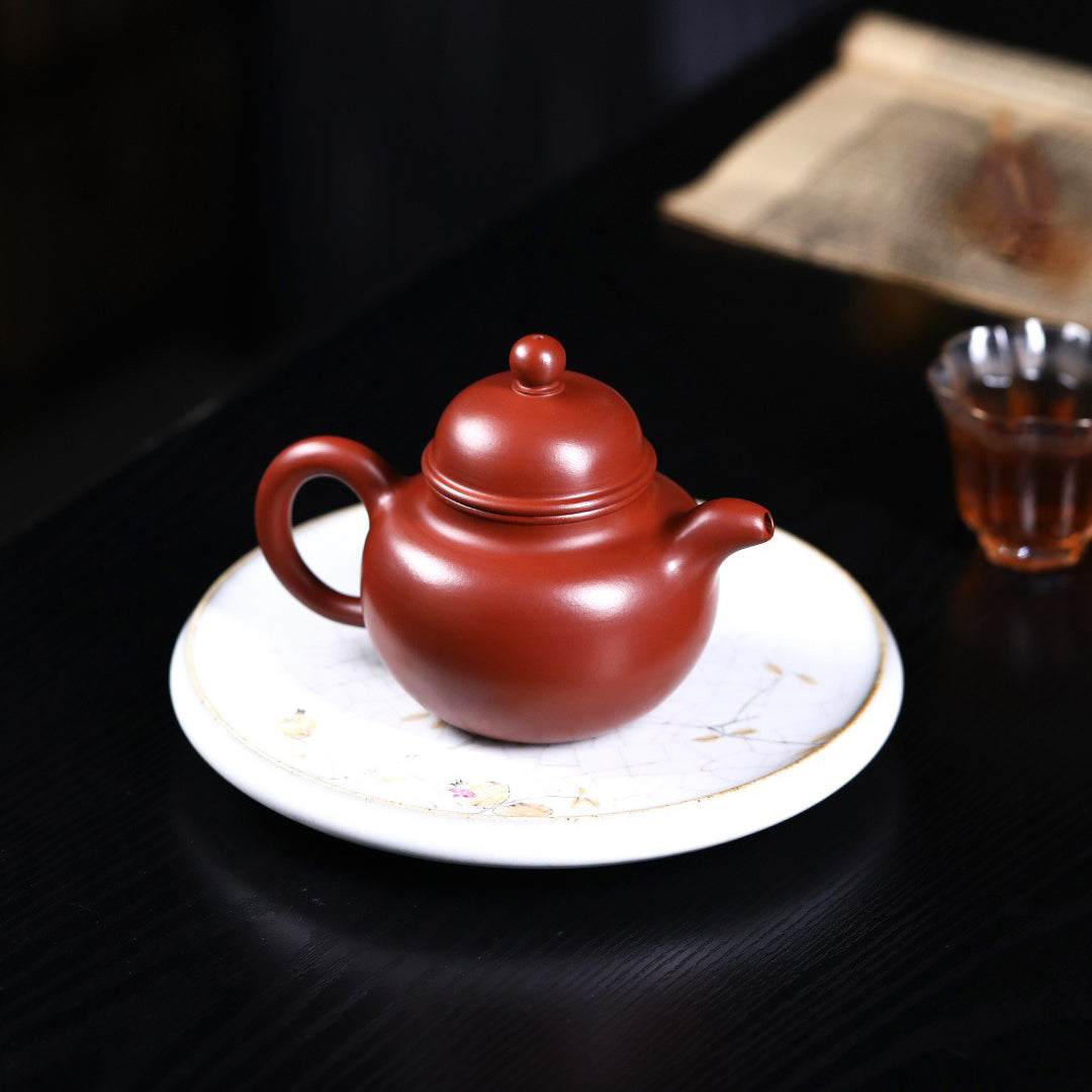 Yixing red clay teapot filled with freshly brewed Gongfu tea, highlighting its functionality and elegance.