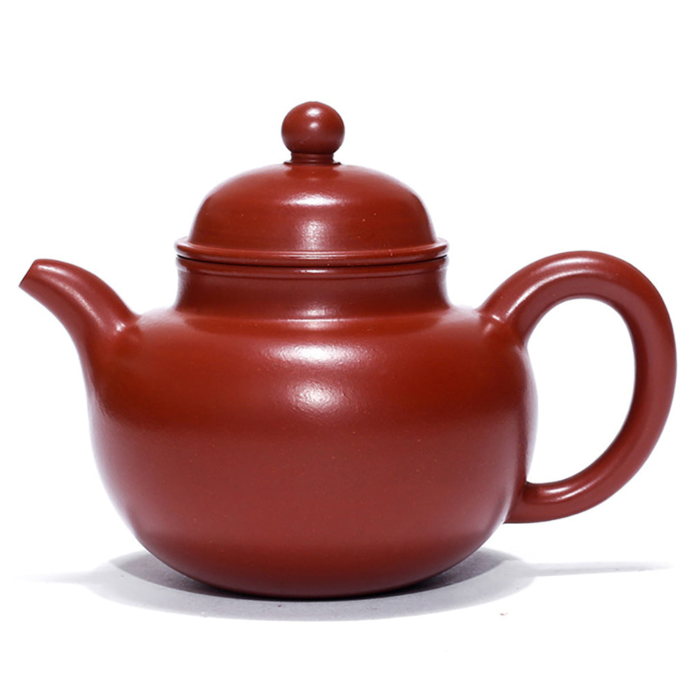 Angled view of the Yixing red clay big belly teapot, displaying its smooth lines and craftsmanship.
