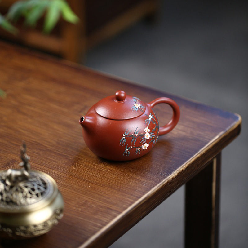 Elegant purple clay teapot filled with tea, highlighting its artistic craftsmanship.
