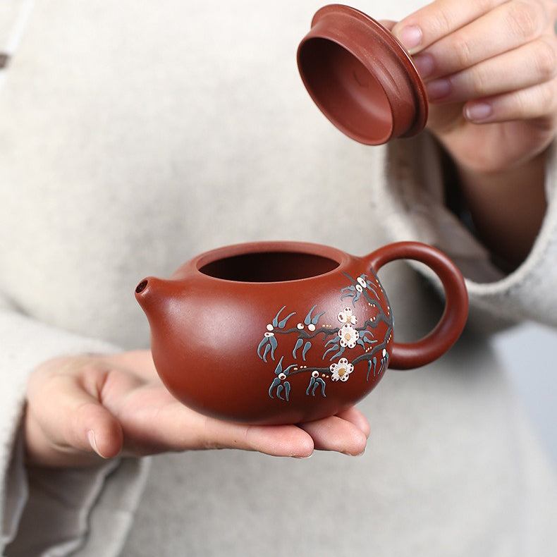 Elegant purple clay teapot filled with tea, highlighting its artistic craftsmanship.