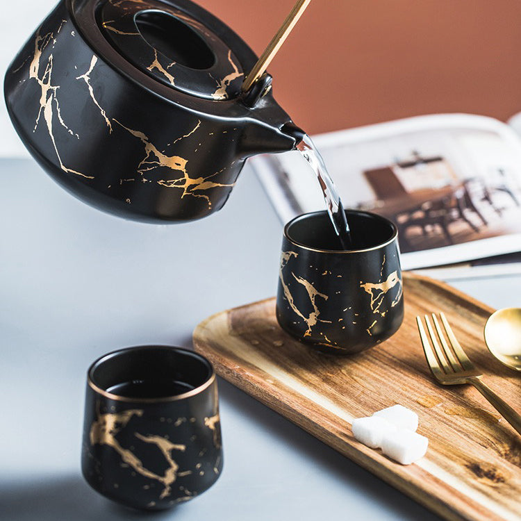 Tea set with cups, water pot, and wooden tray arranged for serving