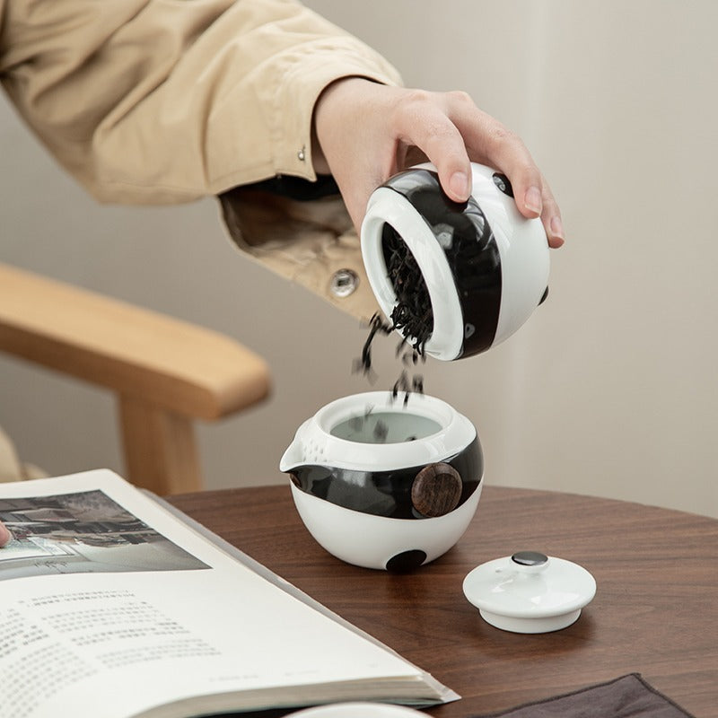 Ceramic tea set in travel bag, ideal for outdoor adventures.