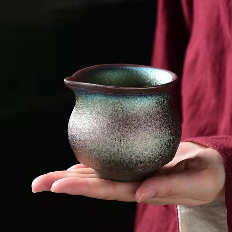 Gaiwan and tea cups from the Handmade Jian Zhan tea set arranged beautifully, emphasizing the rich colors and textures.