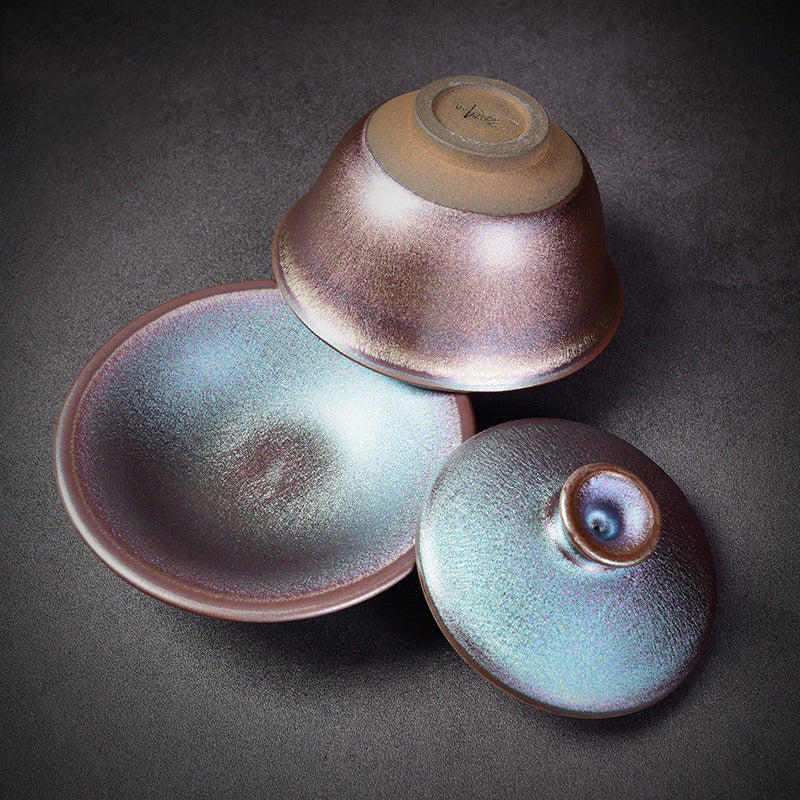Artisan Tenmoku Tianmu Jian Zhan tea set displayed on a wooden table, highlighting its elegant design and craftsmanship.