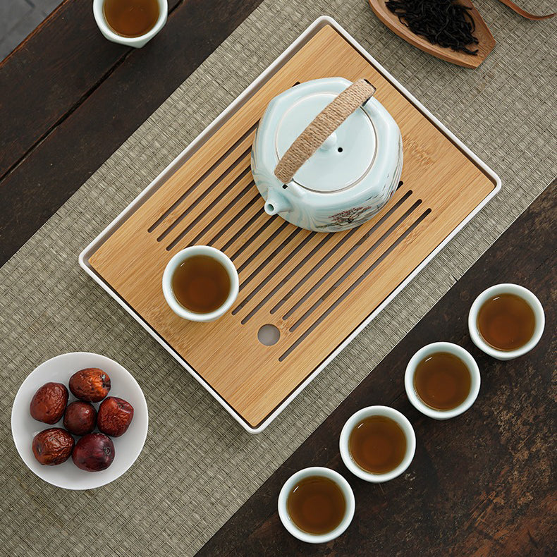 Tea set components including cups, tray, and gift box arranged beautifully.