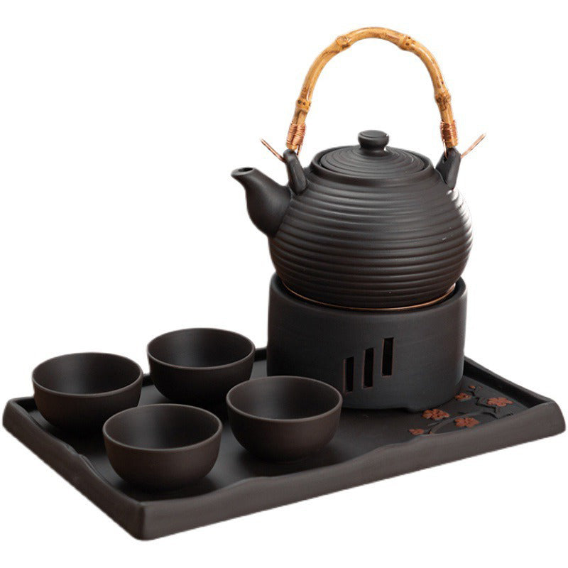 Overhead shot of the Japanese tea set arranged on a wooden tray with the clay teapot centered