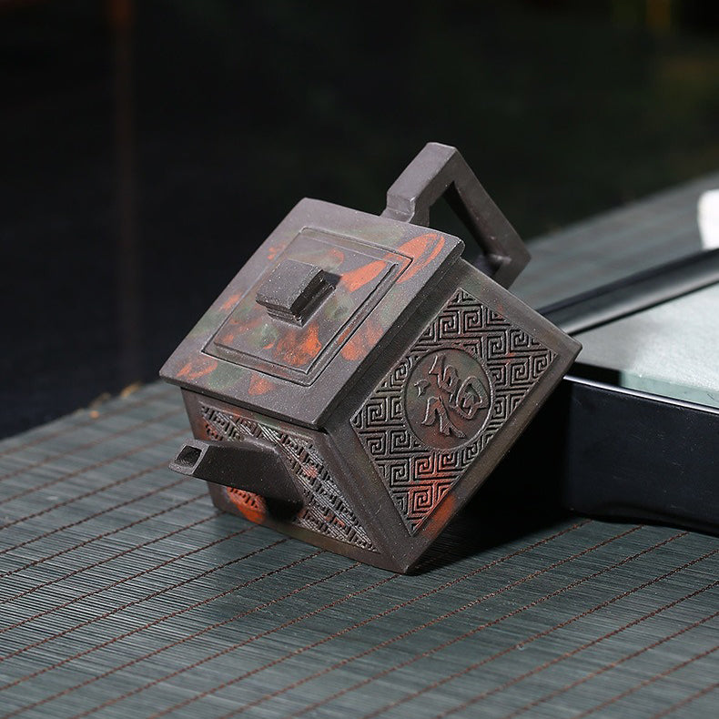 Happiness & Longevity Yixing Teapot showcasing its square design and carvings.