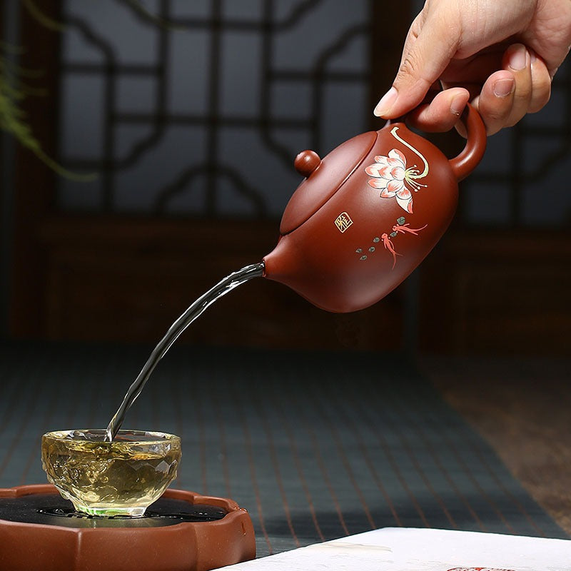 Close-up of handcrafted Yixing red clay lotus teapot showcasing detailed floral design