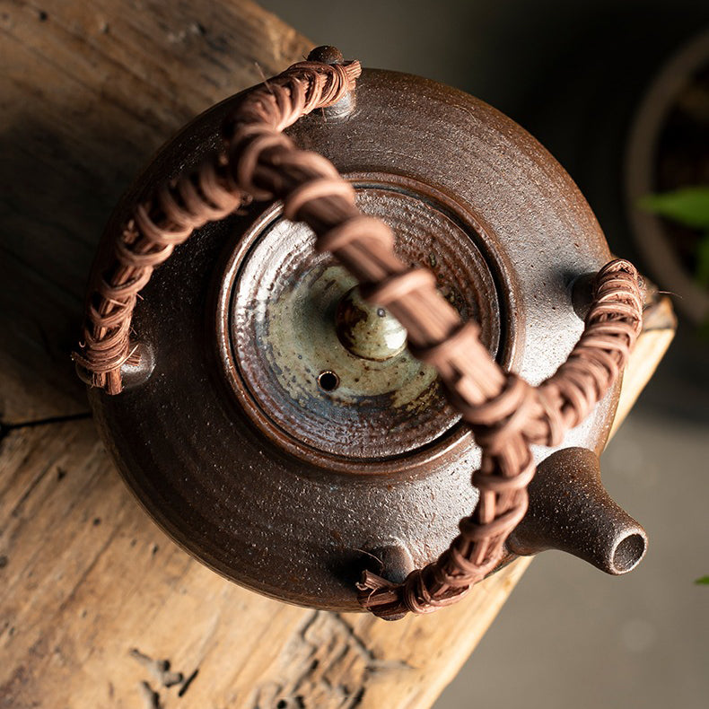 Elegant Japanese bamboo handle teapot from a side angle, showcasing its unique design.