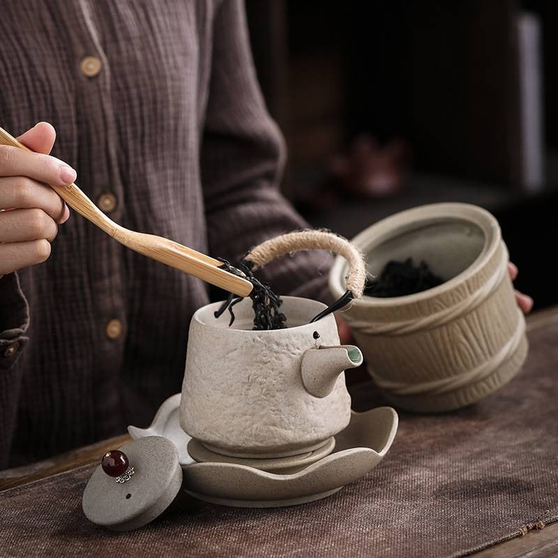 Japanese teapot in use, serving steaming tea in a serene setting.