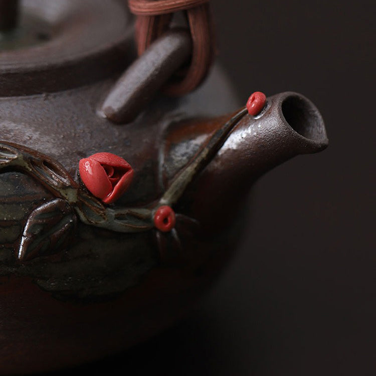 Close-up of the Elegant Japanese Rattan Weaving Teapot highlighting its intricate floral patterns and rattan handle.